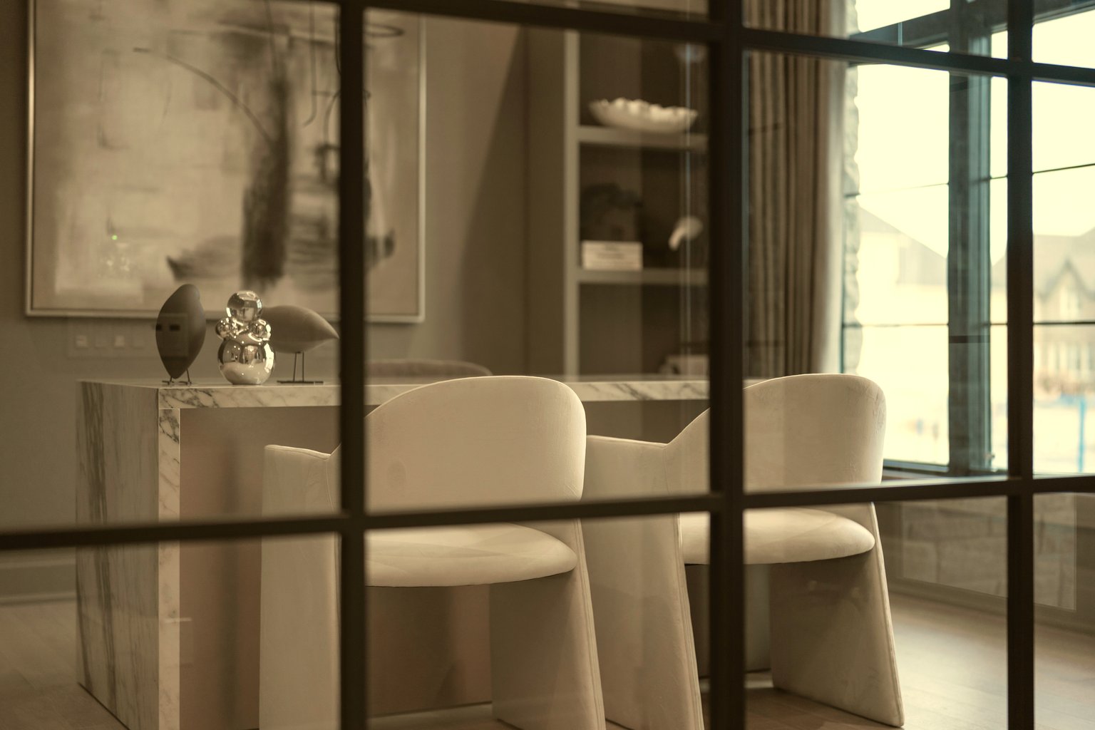 A quiet Rubellite meeting room — marble table, soft daylight, space for unhurried conversation